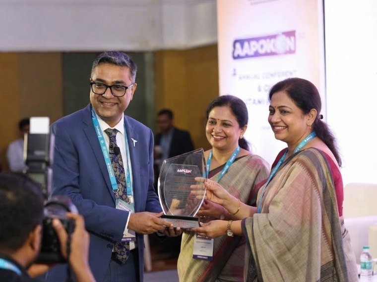 Dr. Gaurab Bhaduri receiving an award trophy at the AAPOKON annual conference.